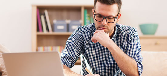 Person sitting at a desk contemplating their options.