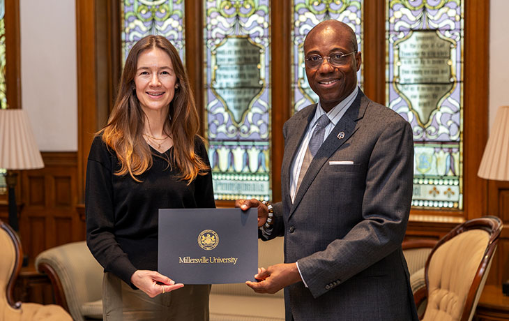 Dr. Wubah congratulates  Dr. Sarah Brooks for receiving the Spring Skully's Circle Award