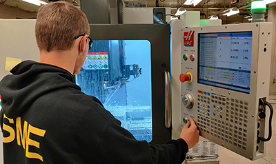 MFET student using CNC milling machine