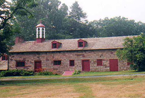 The Elizabeth Furnace Plantation core area includes (left to right) the summer kitchen, the Stiegel Office, the Hessian barracks, and an original Icehouse. The Hessian barracks are so named for the Hessian prisoners kept here during the Revolutionary War. Captured by General Washington at the battle of Trenton in 1777, the Hessians were used as laborers to augment the production of Elizabeth Furnace, which produced cannonballs for the Continental Army and was vital to the American war effort. These barracks still have iron bars across the windows, placed there in 1777.