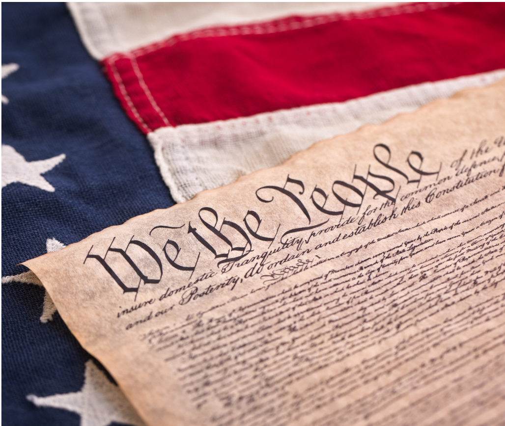 The U.S. Constitution laying on the American flag