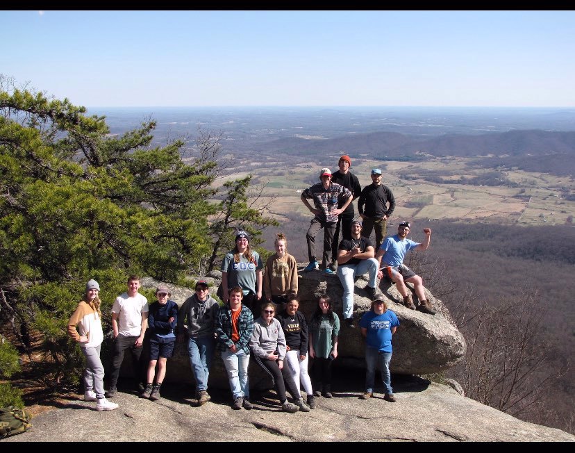 Millersville Conestoga Club members posing on rock formation after a hike.