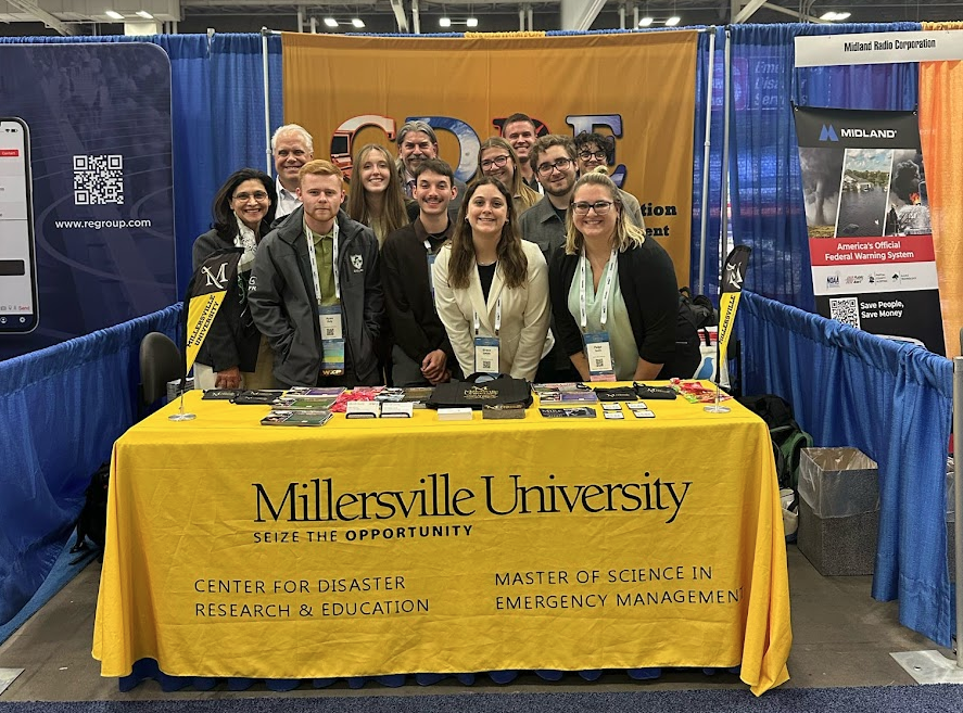 Faculty and students at the Millersville University table for CDRE at a 2025 conference.
