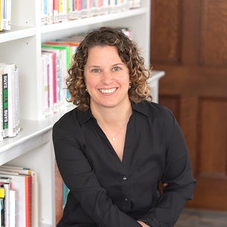 Dr. Molly Ness, seated in front of bookshelves