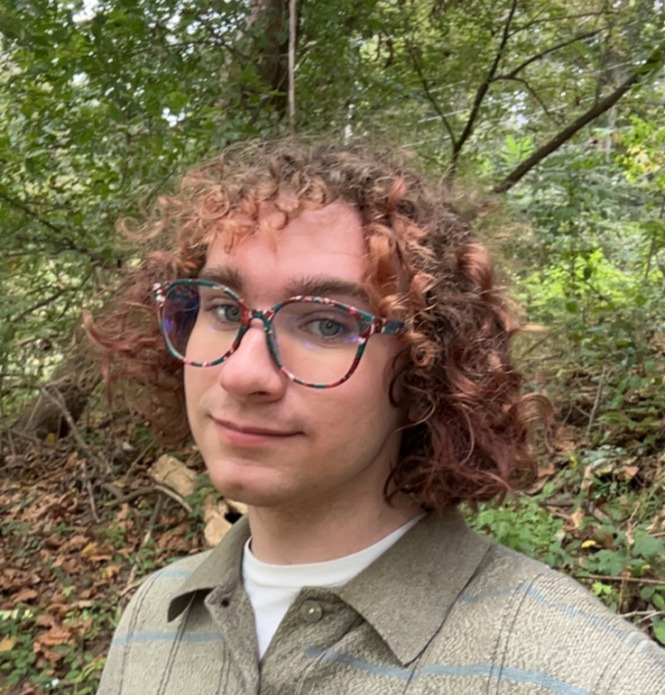 Headshot of Cameron with a background of trees