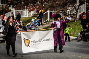 Honors College carrying a banner