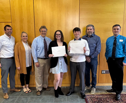 Faculty standing with scholarship recipients