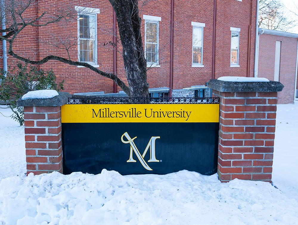 MU sign on a brick wall