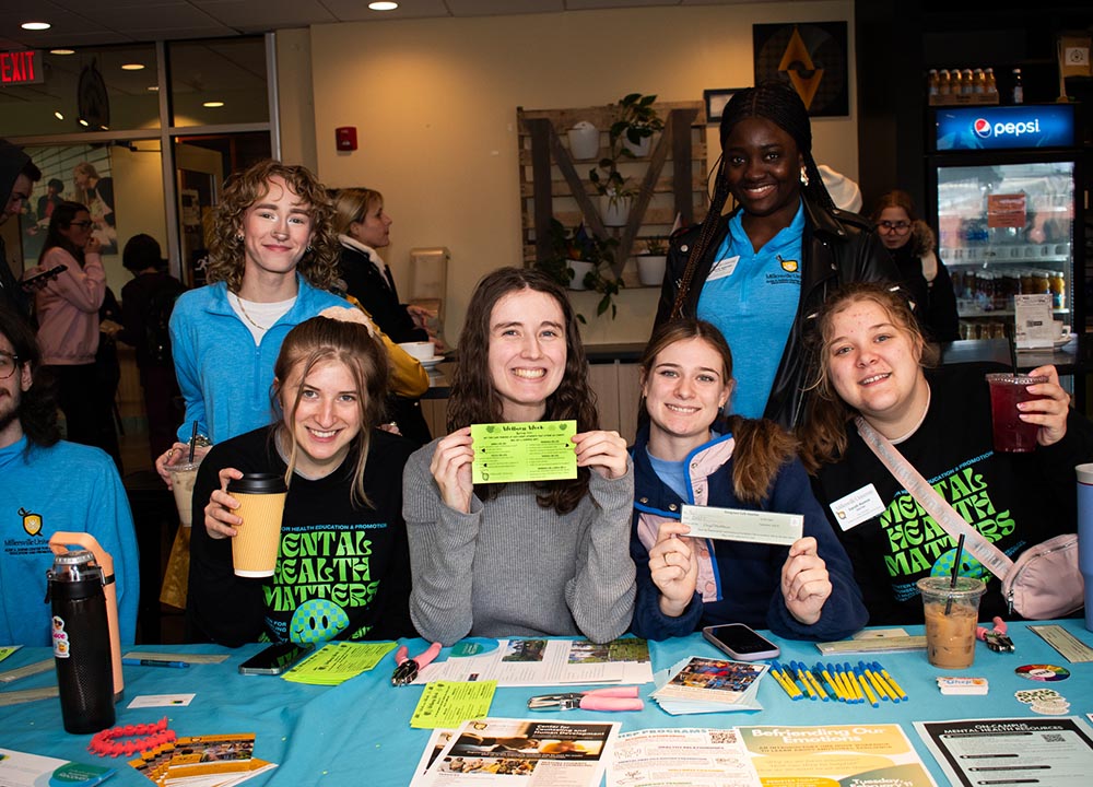 Group of female students at a table promoting CHEP