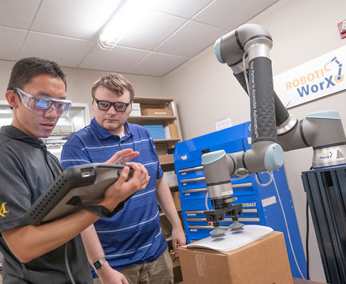 two students working on a robot