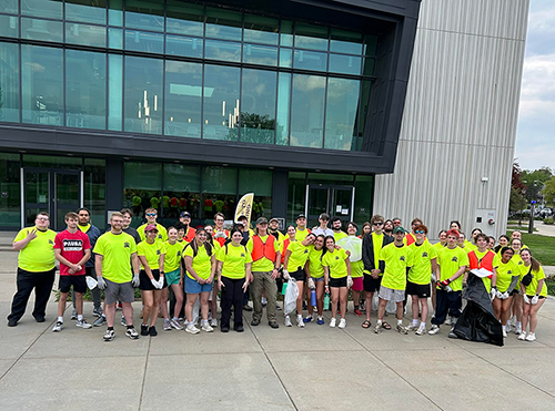 Members of the Conestoga outdoor club gather for a photo in front of Gordinier.
