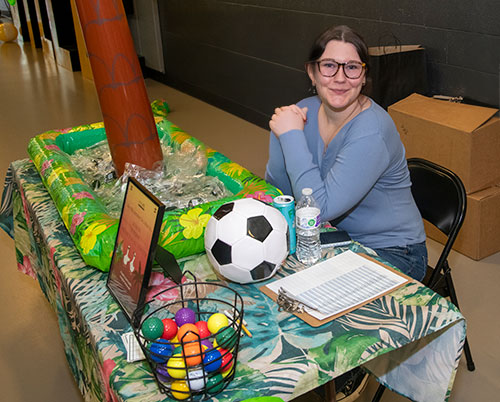 Attendant sitting at the registration table for the all-employee BBQ