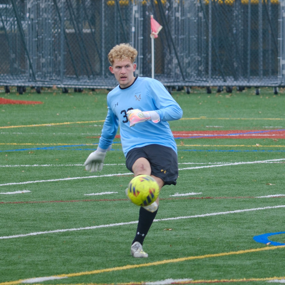 male soccer player kicking the ball