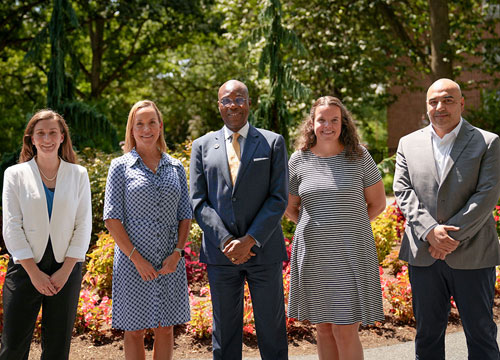 Four new faculty standing with Dr. Wubah