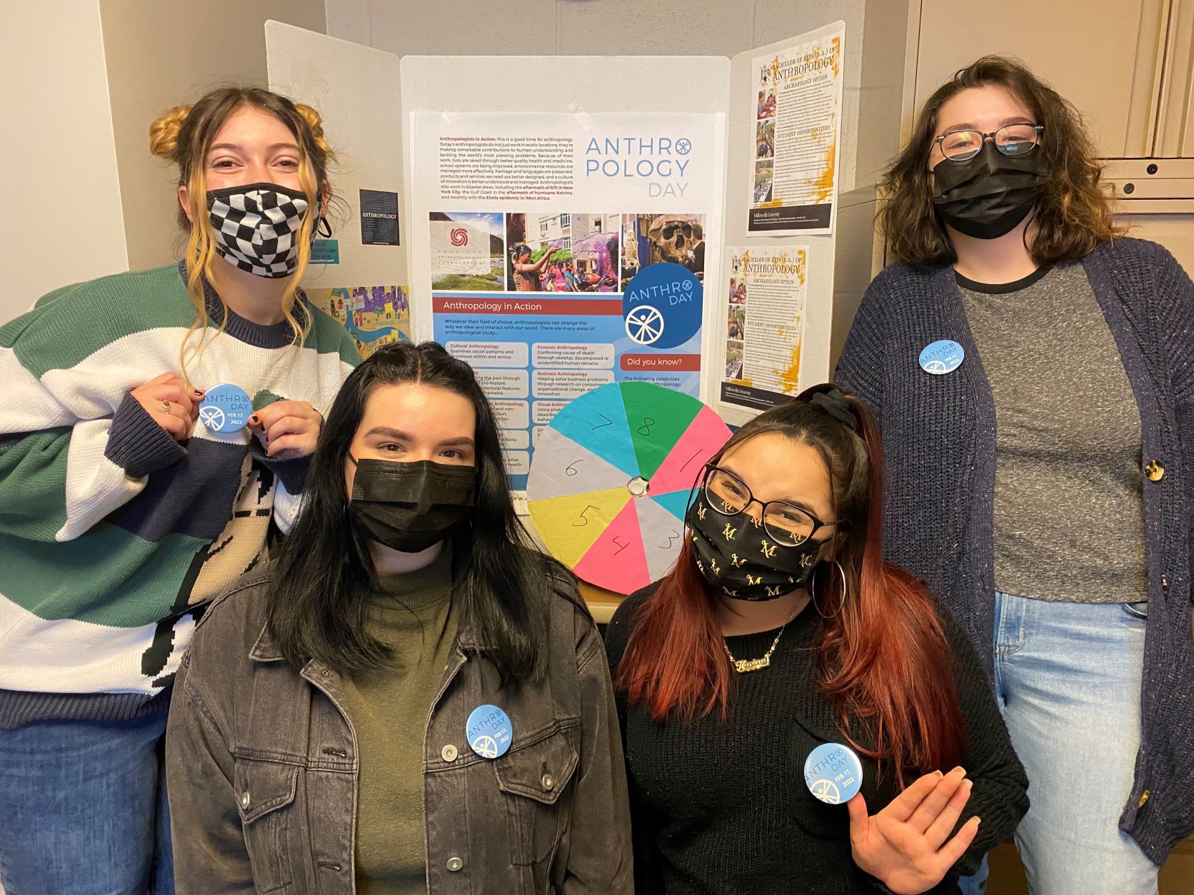 female students pose with anthro day pins