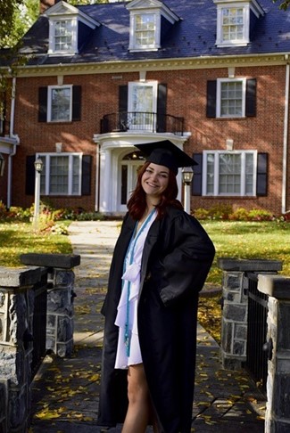 Kaitlyn Dougherty in gown and mortarboard cap