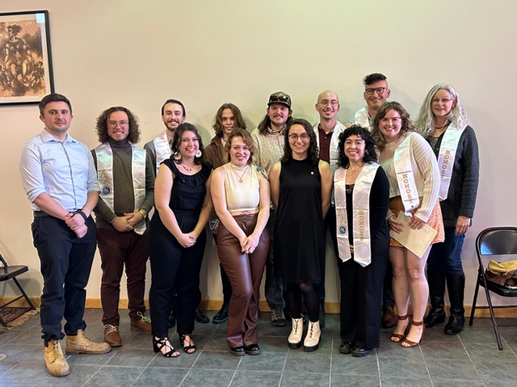 members of lambda alpha national honor society pose with pins and shawls